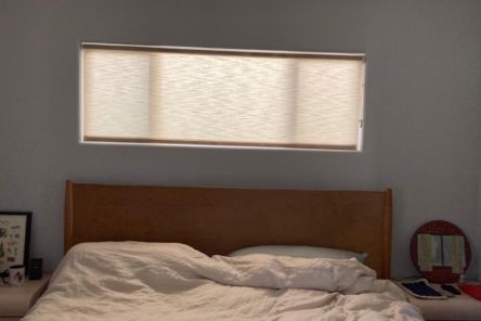 Close-up of modern sheer shades installed on a Cupertino bedroom window, highlighting the elegant fabric and smooth pull down mechanism.